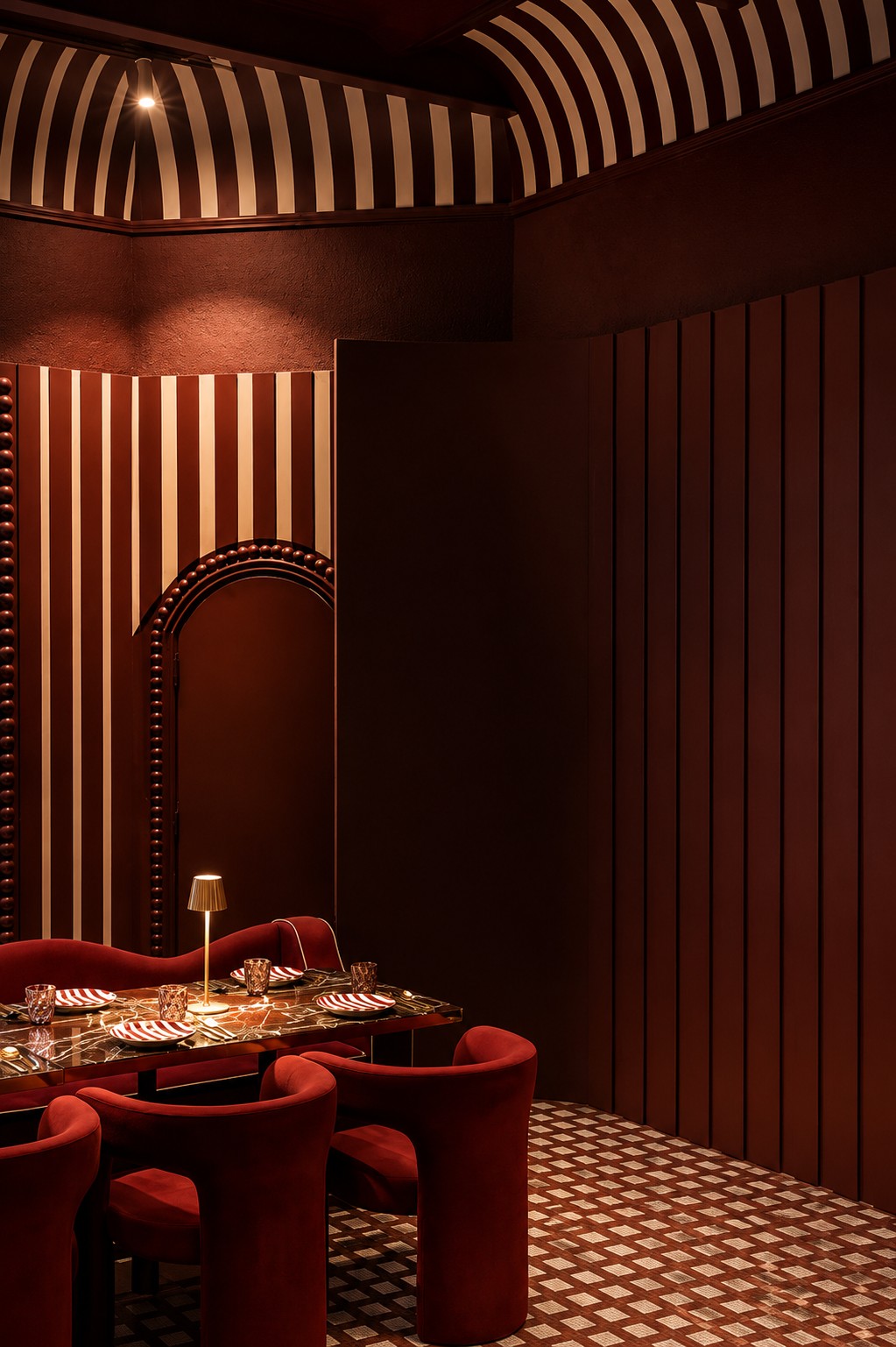 Oxblood velvet chairs on a checkerboard tile floor